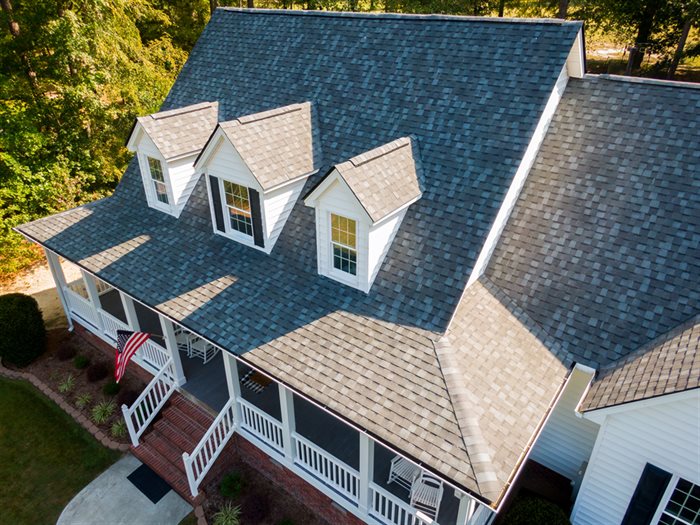 Aerial view of a shingle roof with dormer windows